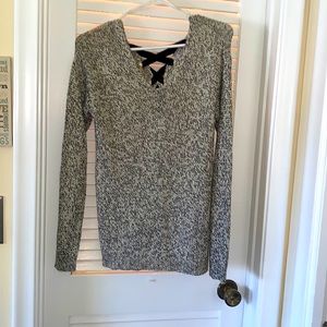 Alya beige & black sweater with black tie up in the back.